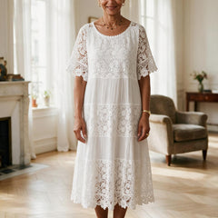 Robe Adèle en dentelle blanche à manches courtes, portée dans un appartement parisien