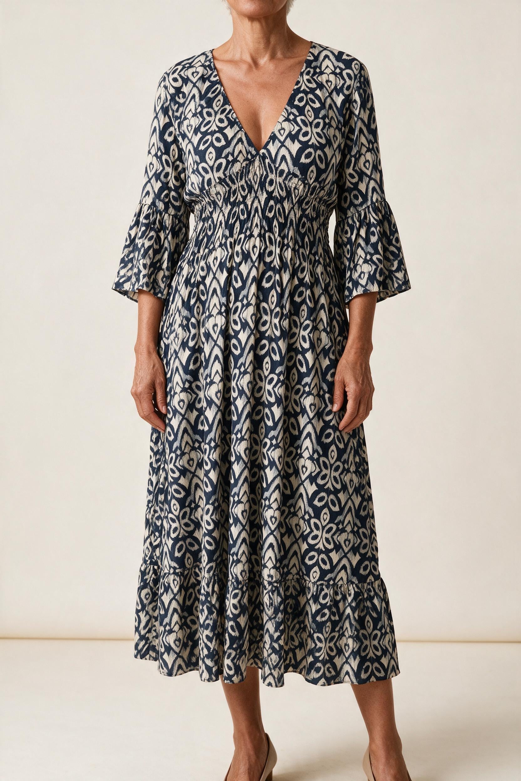 Robe midi Roseline, coloris bleu marine — imprimé ikat, col en V, taille smockée et manches 3/4 à volant, vue de face